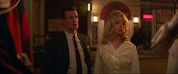 Movie still from “Last Night in Soho” (2021), directed by Edgar Wright – A man and a woman standing next to each other; Medium shot, High angle