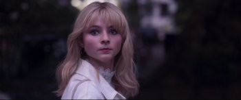 Movie still from “Last Night in Soho” (2021), directed by Edgar Wright – A beautiful young woman with long blonde hair and blue eyes; Close Up shot, Low angle