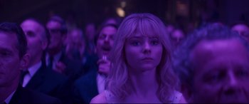Movie still from “Last Night in Soho” (2021), directed by Edgar Wright – A woman in a crowd of people in a purple light; Close Up shot, Over the shoulder angle