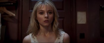 Movie still from “Last Night in Soho” (2021), directed by Edgar Wright – A young woman with blonde hair and a white dress; Close Up shot, Over the shoulder angle