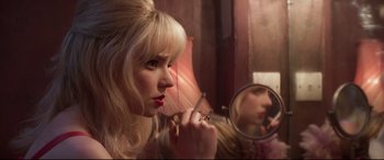 Movie still from “Last Night in Soho” (2021), directed by Edgar Wright – A woman is looking in the mirror and smoking a cigarette; Close Up shot, Over the shoulder angle