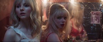 Movie still from “Last Night in Soho” (2021), directed by Edgar Wright – A woman with blonde long hair and a red dress; Close Up shot, Low angle