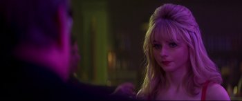 Movie still from “Last Night in Soho” (2021), directed by Edgar Wright – A woman with blonde hair is looking at the camera; Close Up shot, Over the shoulder angle
