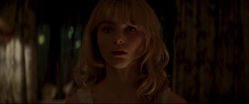 Movie still from “Last Night in Soho” (2021), directed by Edgar Wright – A woman with blonde hair and a white top; Close Up shot, Low angle