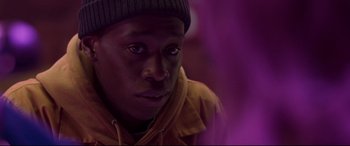 Movie still from “Last Night in Soho” (2021), directed by Edgar Wright – A person wearing a hat; Close Up shot, Over the shoulder angle