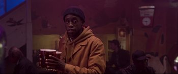 Movie still from “Last Night in Soho” (2021), directed by Edgar Wright – A man holding a cup in his hands; Medium shot, Over the shoulder angle