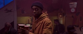 Movie still from “Last Night in Soho” (2021), directed by Edgar Wright – A man in a brown jacket holding a cup of coffee; Close Up shot, Over the shoulder angle