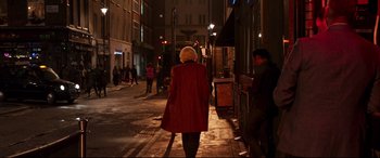 Movie still from “Last Night in Soho” (2021), directed by Edgar Wright – A woman walking down a street at night; Wide shot, Over the shoulder angle