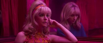 Movie still from “Last Night in Soho” (2021), directed by Edgar Wright – A woman in a pink dress and a woman in a yellow dress; Medium shot, Low angle