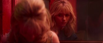 Movie still from “Last Night in Soho” (2021), directed by Edgar Wright – A woman looking at her reflection in a mirror; Close Up shot, Over the shoulder angle