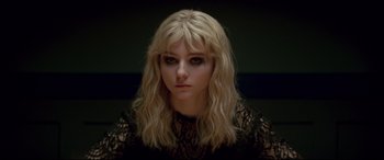 Movie still from “Last Night in Soho” (2021), directed by Edgar Wright – A woman with long blonde hair wearing a black lace top; Close Up shot, High angle