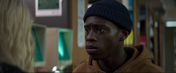 Movie still from “Last Night in Soho” (2021), directed by Edgar Wright – A person wearing a hat; Close Up shot, Over the shoulder angle