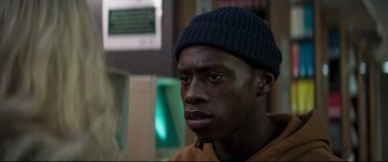 Movie still from “Last Night in Soho” (2021), directed by Edgar Wright – A person wearing a hat; Close Up shot, Over the shoulder angle