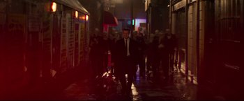Movie still from “Last Night in Soho” (2021), directed by Edgar Wright – A group of people walking down a street at night; Extreme Wide shot, High angle