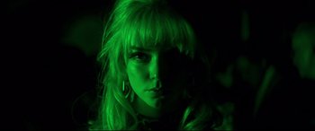 Movie still from “Last Night in Soho” (2021), directed by Edgar Wright – A woman with blonde hair and green lighting; Close Up shot, Low angle