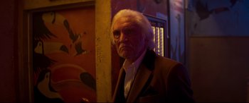 Movie still from “Last Night in Soho” (2021), directed by Edgar Wright – An old man with a white beard and a white mustache; Close Up shot, Low angle