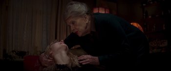 Movie still from “Last Night in Soho” (2021), directed by Edgar Wright – An older woman and a younger woman in a dark room; Close Up shot, High angle