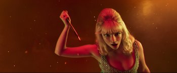 Movie still from “Last Night in Soho” (2021), directed by Edgar Wright – A woman holding a stick in her hand; Close Up shot, Low angle