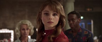 Movie still from “Last Night in Soho” (2021), directed by Edgar Wright – A woman with long brown hair wearing a red shirt; Close Up shot, Over the shoulder angle