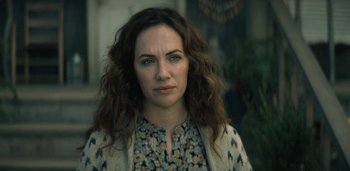 Movie still from “Midnight Mass” (2021), directed by Mike Flanagan – A person with long curly hair; Close Up shot, Over the shoulder angle