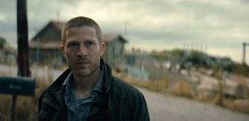 Movie still from “Midnight Mass” (2021), directed by Mike Flanagan – A person standing on a street; Close Up shot, Low angle