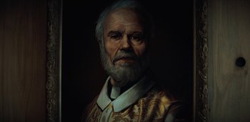 Movie still from “Midnight Mass” (2021), directed by Mike Flanagan – A painting of a man with a beard; Close Up shot, Low angle