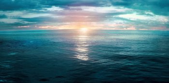 Movie still from “Midnight Mass” (2021), directed by Mike Flanagan – The sun is setting over a body of water; Extreme Wide shot, High angle