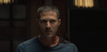 Movie still from “Midnight Mass” (2021), directed by Mike Flanagan – A person wearing a blue shirt; Close Up shot, Low angle