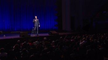 Movie still from “Mike Epps: Only One Mike” (2019), directed by Kevin Bray – A man standing on a stage in front of an audience; Extreme Wide shot, High angle