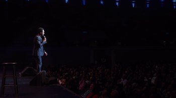 Movie still from “Mike Epps: Only One Mike” (2019), directed by Kevin Bray – A man standing in front of an audience on a stage; Extreme Wide shot, High angle