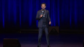 Movie still from “Mike Epps: Only One Mike” (2019), directed by Kevin Bray – A man standing on a stage with a microphone; Medium shot, High angle