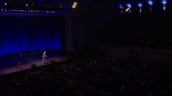 Movie still from “Mike Epps: Only One Mike” (2019), directed by Kevin Bray – A man standing on a stage in front of an audience; Extreme Wide shot, High angle