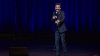 Movie still from “Mike Epps: Only One Mike” (2019), directed by Kevin Bray – A man standing on a stage holding a microphone; Medium shot, High angle