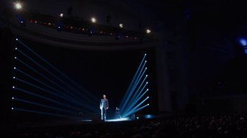 Movie still from “Mike Epps: Only One Mike” (2019), directed by Kevin Bray – A man standing on a stage in front of an audience; Extreme Wide shot, High angle