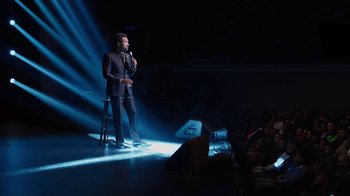Movie still from “Mike Epps: Only One Mike” (2019), directed by Kevin Bray – A man standing on a stage with a microphone; Wide shot, High angle