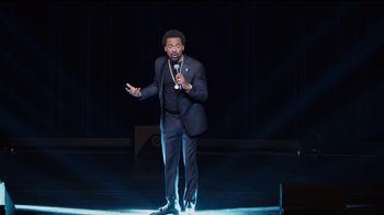 Movie still from “Mike Epps: Only One Mike” (2019), directed by Kevin Bray – A man standing on a stage with a microphone; Medium shot, High angle