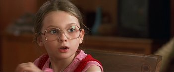 Movie still from “Little Miss Sunshine” (2006), directed by Jonathan Dayton – A little girl wearing glasses and a pink shirt; Close Up shot, High angle