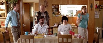 Movie still from “Little Miss Sunshine” (2006), directed by Jonathan Dayton – Three people are sitting at a table in a room; Medium shot, Over the shoulder angle