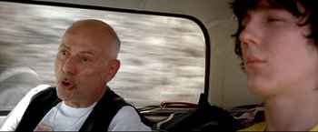 Movie still from “Little Miss Sunshine” (2006), directed by Jonathan Dayton – An older man riding a bus on the street; Close Up shot, Over the shoulder angle