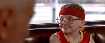 Movie still from “Little Miss Sunshine” (2006), directed by Jonathan Dayton – A young girl wearing glasses and a red headband; Close Up shot, Over the shoulder angle