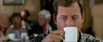 Movie still from “Little Miss Sunshine” (2006), directed by Jonathan Dayton – A person drinking from a mug; Close Up shot, Low angle