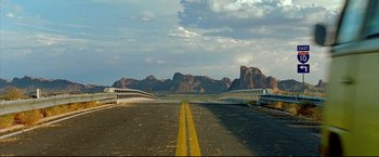 Movie still from “Little Miss Sunshine” (2006), directed by Jonathan Dayton – A road that has a bridge going over it; Extreme Wide shot, High angle