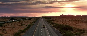 Movie still from “Little Miss Sunshine” (2006), directed by Jonathan Dayton – Two cars driving down a highway at sunset; Extreme Wide shot, Low angle