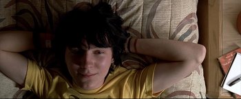 Movie still from “Little Miss Sunshine” (2006), directed by Jonathan Dayton – A person laying on a bed wearing a yellow shirt; Close Up shot, Overhead angle