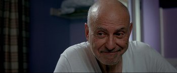 Movie still from “Little Miss Sunshine” (2006), directed by Jonathan Dayton – An older man with a shaved bald head; Close Up shot, Low angle