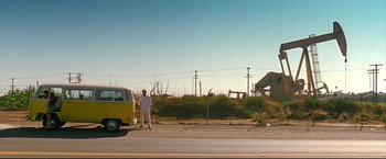 Movie still from “Little Miss Sunshine” (2006), directed by Jonathan Dayton – A man standing on the side of a road next to a van; Wide shot, Low angle