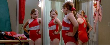 Movie still from “Little Miss Sunshine” (2006), directed by Jonathan Dayton – A girl in a red leotard looking in the mirror; Medium shot, Over the shoulder angle