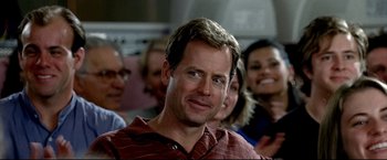 Movie still from “Little Miss Sunshine” (2006), directed by Jonathan Dayton – A group of people standing around a man in front of a camera; Close Up shot, Over the shoulder angle