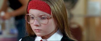 Movie still from “Little Miss Sunshine” (2006), directed by Jonathan Dayton – A young girl wearing glasses and wearing a red headband; Close Up shot, High angle
