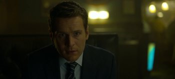 Movie still from “Mindhunter” (2017), directed by Tobias Lindholm – A person wearing a suit and tie; Close Up shot, Low angle